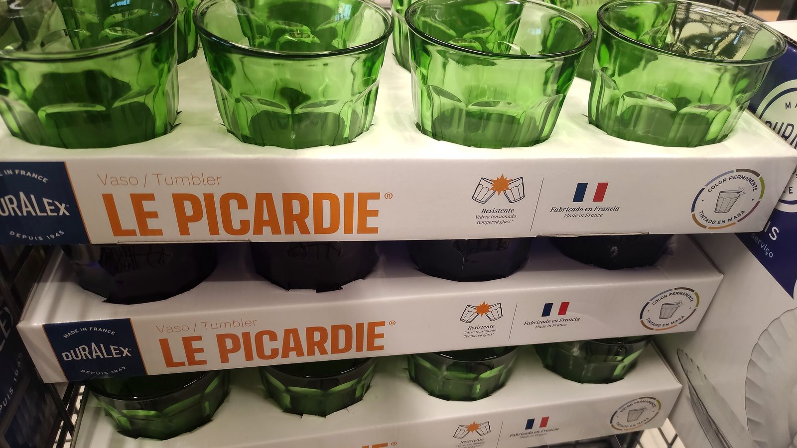 Verres Le Picardie de Duralex, de couleur verte, rangés dans leurs coffrets de six sur un présentoir de magasin, mention fabriqué en France
